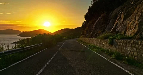 Driving a Car on a mountain Road at sunset. Beautiful road and mountain Stock Footage 223842222