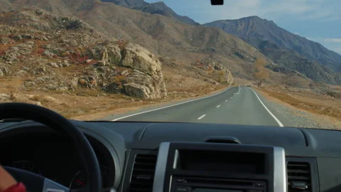 Driving car on mountain road through arid landscape 库存影片 335215367