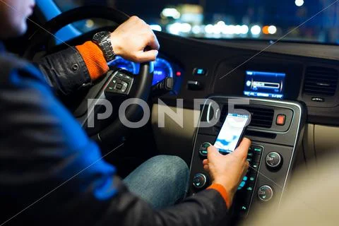 Driving a car at night -man driving his modern car at night in a Stock Photos