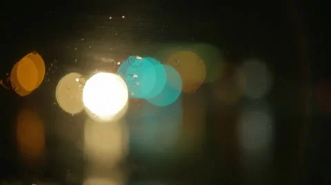 Driving a car at night. Raindrops on the windshield. Different colourful lights. Stock Footage 68028600