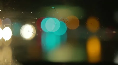 Driving a car at night. Raindrops on the windshield. Green, red, white lights. Stock Footage 68029283