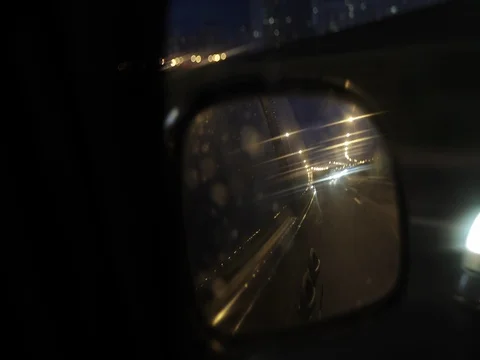 Driving a car at night. The side mirror is close-up. Stock Footage 77148295