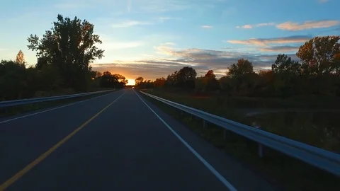 Driving a Car in Point of View Perspective on a Road into Sunset - 7 Video stock 84868243