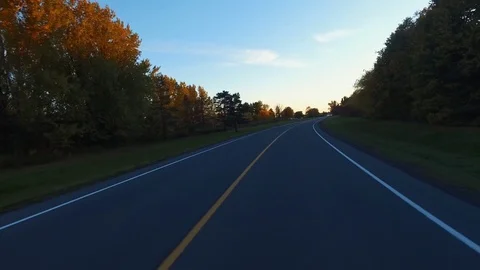 Driving a Car in Point of View Perspective on a Road into Sunset - 3 Stock Footage 84868249