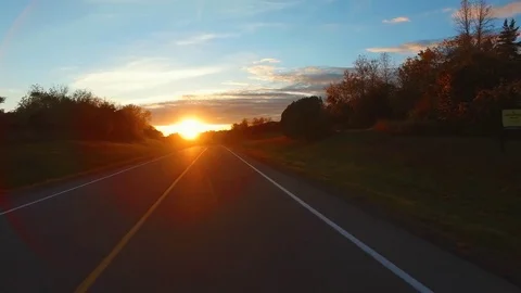 Driving a Car in Point of View Perspective on a Road into Sunset - 8 Video stock 84868597