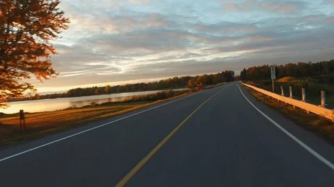Driving a Car in Point of View Perspective on a Road into Sunset - 13 Video stock 84868863