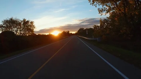Driving a Car in Point of View Perspective on a Road into Sunset - 5 Stock Footage 84869130