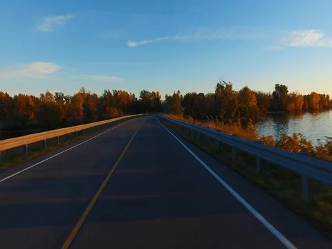 Driving a Car in Point of View Perspective on a Road into Sunset - 2 Stock Footage 84869514