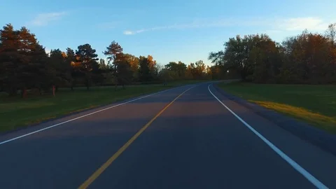 Driving a Car in Point of View Perspective on a Road into Sunset. Stock Footage 84869976