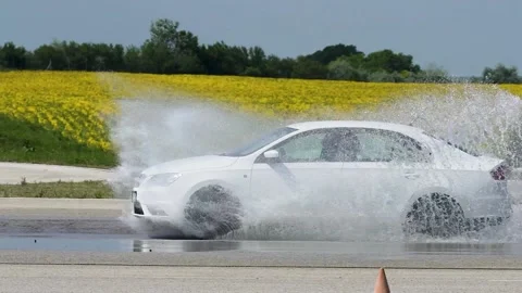 Driving a car in rainy conditions on a simulation practice track. Stock Footage 151749498
