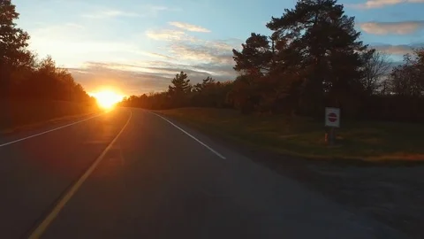 Driving a Car on a Road into Sunset Stock-Footage 84869792