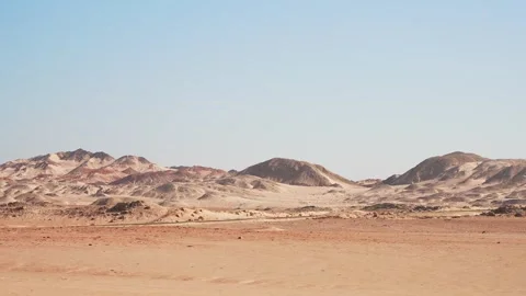 Driving car side view to the mountains in the desert at hot day. African road Stock Footage 253992463