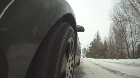 Driving car on snow - wheel view 01 Stock Footage