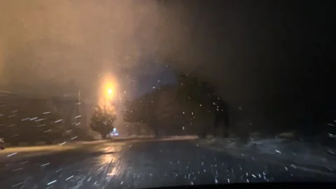 Driving a car in snowfall. Snowfall through the windshield of a car. Snow falls Stock Footage 261222631