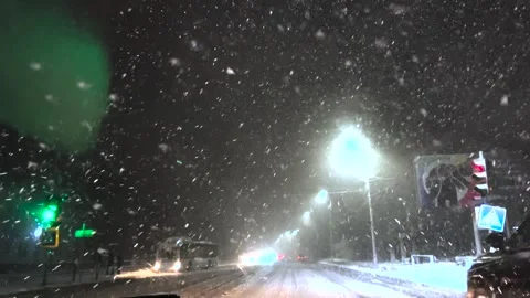 Driving a car in snowfall. Snowfall through the windshield of a car. Snow falls Stock Footage 263148723