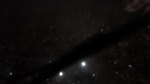 Driving a car in snowfall. Snowfall through the windshield of a car. Snow falls Stock Footage 263731498