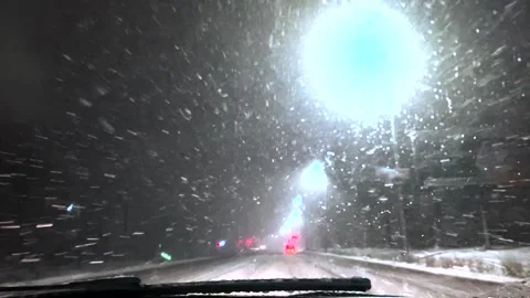 Driving a car in snowfall. Snowfall through the windshield of a car. Snow falls Stock Footage 264540985