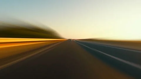 Driving a car on sunset highway blurred motion POV Stock Footage