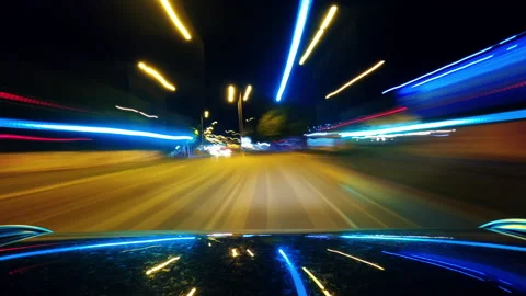 Driving car through city at night, hyper lapse footage Stock Footage