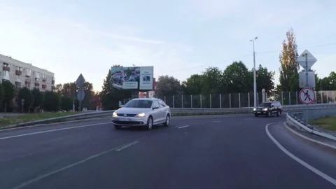 Driving a car through the evening city. Cars are driving on the highway in th Stock Footage 80796685