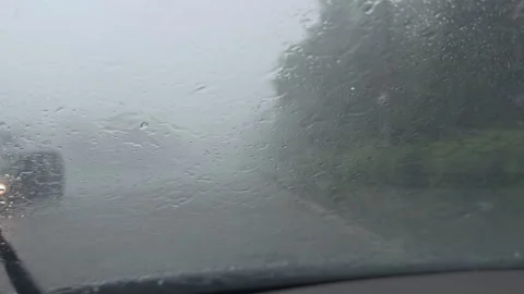 Driving a car through heavy rain and foggy weather Stock Footage 338408973