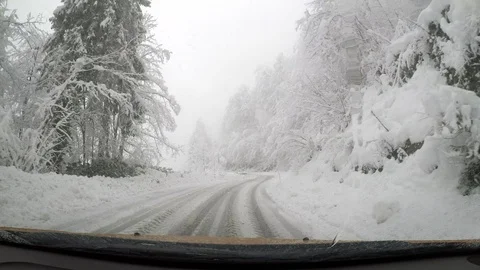 Driving car through snow . Danger road. Ice and snow covered asphalt road. Stock Footage 85691539