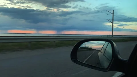Driving a car in thunderstorm during the sunset Stock Footage 310265978