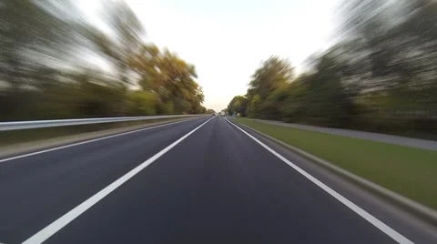 Driving a car timelapse. POV camera is attached to the hood. Sunset time. Stock Footage 42786016