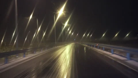 Driving a car with the windshield wipers on on a dark winter night Stock-Footage 237777030