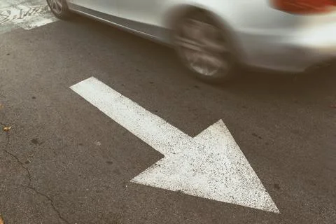 Driving car in wrong direction against traffic arrow sign 스톡 사진