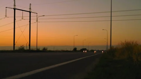 Driving Cars with Headlights on the Dawn Highway Stock Footage