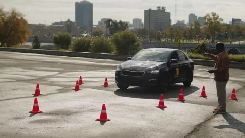 Driving Coach Instructing Student to Navigate Learners Vehicle Stock Footage 276540677