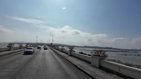Driving Coastal Road Bordered by Calm Sea Water Stock Footage 342573056