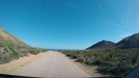 Driving to coastline of Spain on bumpy road, POV Video stock 317225142