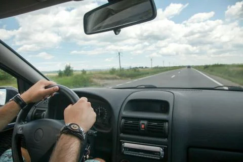 Driving concept  driver hands on wheel and car interior Stock Photos