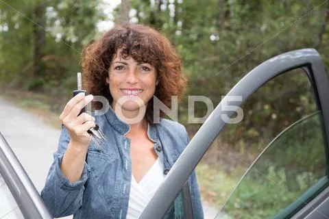Driving concept -happy smiling woman with car key Stock Photos