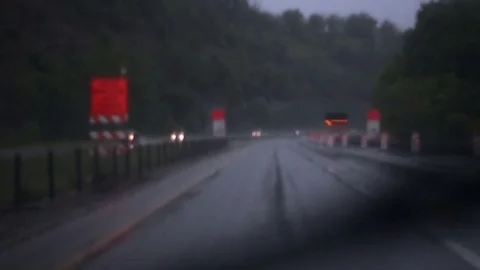 Driving into construction zone during chaotic thunderstorm - POV angle Stock Footage 75972532