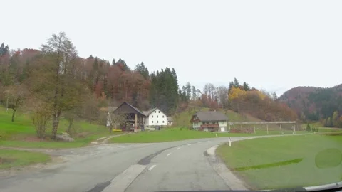 Driving on countryside road surrounded with forest Stock Footage 167686433
