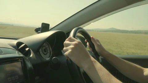 Driving in the countryside sunset time. Hands on the steering wheel. Slow motion Stock Footage 84842764