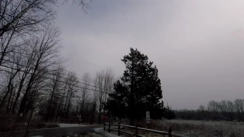 Driving county road in park and rural area on snowy day in winter Stock Footage 281258479