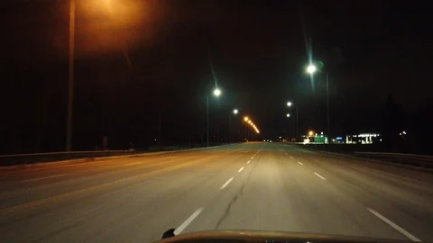 Driving Cruising Down An Empty Highway At Night Passing A Gas Station With Ov Stock Footage 105126087