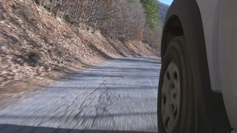 Driving on a damaged asphalt road in the mountains. road with many holes Stock Footage 99430153