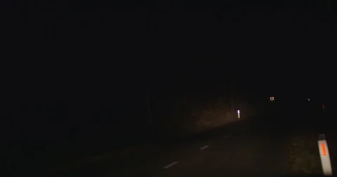 Driving on a dark empty road at night Stock Footage 119666971