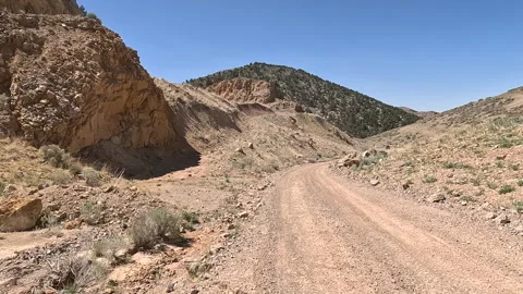 Driving desert mountain mining dirt road Utah POV 4K Stock Footage 307739079