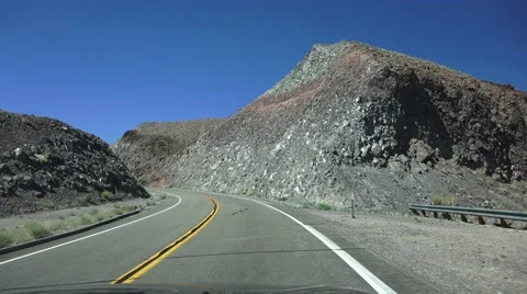Driving desert road through mountain pass Stock Footage 55237816