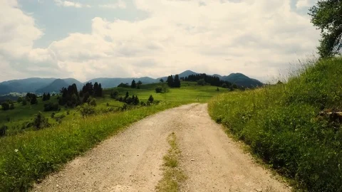 Driving on a dirt mountain road Stock Footage 77396140