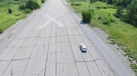Driving down abandoned runway tight shot Stock Footage 68002070