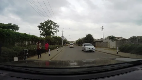 Driving down an African road with a crowd of people walking by Video stock 106909433