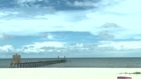 Driving down the beach past a board walk in 4k 60fps Stock Footage 202742400