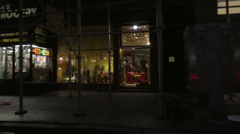 Driving down Broadway at night, scaffolding covering grocery SoHo Manhattan NYC Vidéo 58996233